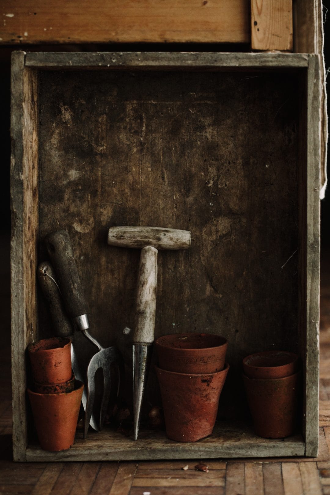 gardening hand tools in a wooden box