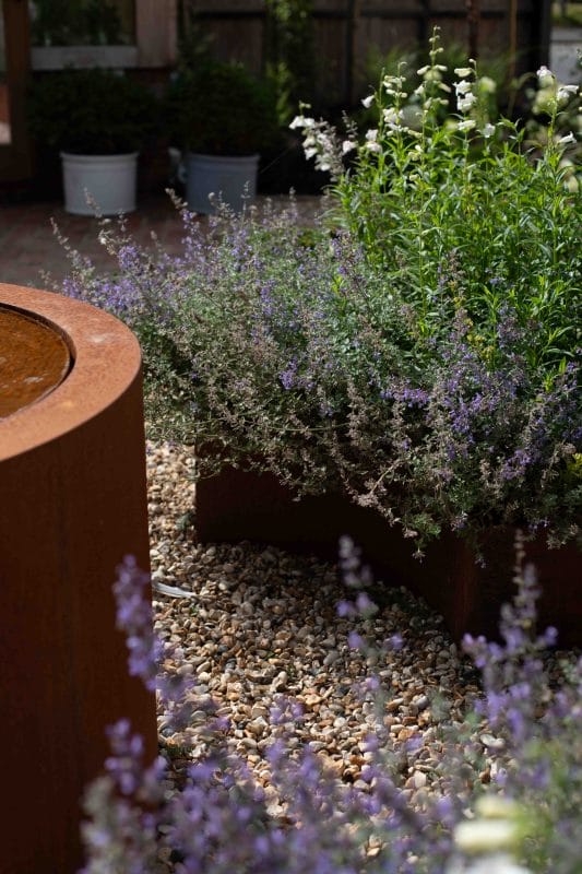 gardening garden design landscaping fountain water feature raised bed flower bed plants gravel secret garden