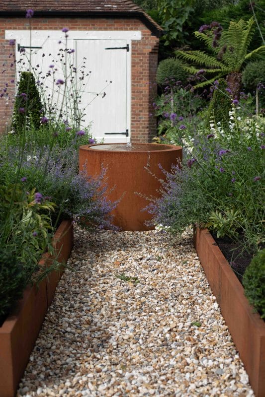 gardening garden design landscaping Surrey horticulture fountain water feature raised bed flower bed pathway gravel