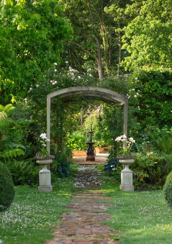 gardening garden design landscaping planting plan Surrey West Sussex archway rose arch flower beds fountain year round interest 
