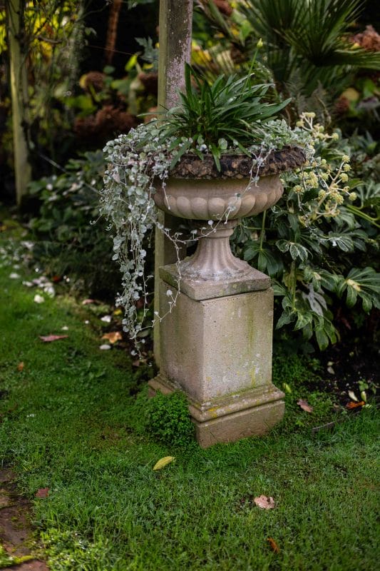 Pair of Composite Stone Garden Urns on Square Pedestals