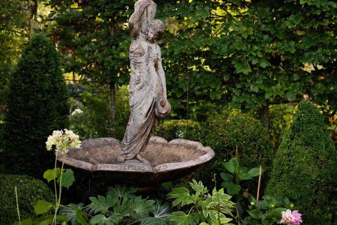 gardening garden design landscaping horticulture Surrey West Sussex fountain water feature topiary buxom taxis cones hedge flower bed fats japonica leaves